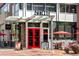 Exterior of NORTH restaurant with red doors and sidewalk patio at 525 Jackson St # 303, Denver, CO 80206