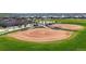 Community baseball field with dugouts, green lawn, and manicured infield, ideal for outdoor sports at 172 Painted Horse Way, Erie, CO 80516