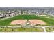 Aerial view of ball fields with green grass and walking paths in a residential area at 172 Painted Horse Way, Erie, CO 80516