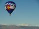 Hot air balloon drifting in clear blue skies over mountain range at 172 Painted Horse Way, Erie, CO 80516