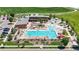 Aerial view of a community pool with ample seating and water features at 172 Painted Horse Way, Erie, CO 80516
