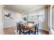 Bright dining room with table and chairs set, featuring modern decor and hardwood floors at 172 Painted Horse Way, Erie, CO 80516