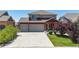 Two-story home featuring a two-car garage, concrete driveway and well maintained lawn at 172 Painted Horse Way, Erie, CO 80516