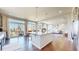 Bright open kitchen featuring hardwood floors, a large island, and modern appliances at 172 Painted Horse Way, Erie, CO 80516