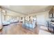 Open-concept kitchen with island, hardwood floors, and seamless flow to living space at 172 Painted Horse Way, Erie, CO 80516