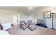 Comfortable living room featuring plush seating, neutral walls, and a modern television setup creating an ideal space for relaxation at 172 Painted Horse Way, Erie, CO 80516