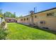 Spacious backyard with manicured lawn, mature trees, and brick home at 2501 E Arkansas Ave, Denver, CO 80210