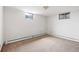Blank canvas basement with carpet and two small windows at 2501 E Arkansas Ave, Denver, CO 80210