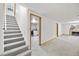 Spacious finished basement with stairs, plush carpeting, and convenient laundry area at 2501 E Arkansas Ave, Denver, CO 80210