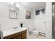 Clean bathroom with a wood vanity, toilet, and a tiled shower at 2501 E Arkansas Ave, Denver, CO 80210