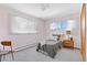 Comfortable bedroom with a full-sized bed, carpeting, and lots of natural light at 2501 E Arkansas Ave, Denver, CO 80210