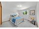 Cozy bedroom featuring carpet, a full-sized bed with throw pillows, and a large window at 2501 E Arkansas Ave, Denver, CO 80210