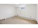 This bedroom features carpet floors, neutral walls, and a small window at 2501 E Arkansas Ave, Denver, CO 80210