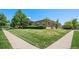 Well-maintained lawn and mature trees surround this corner lot home at 2501 E Arkansas Ave, Denver, CO 80210