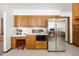 Bright kitchen with a stainless steel refrigerator, plenty of cabinet space, and white countertops at 2501 E Arkansas Ave, Denver, CO 80210