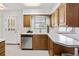Well-lit kitchen featuring stainless steel dishwasher, and white countertops at 2501 E Arkansas Ave, Denver, CO 80210
