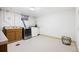 Bright laundry room with sink, storage cabinets, and side-by-side washer and dryer at 2501 E Arkansas Ave, Denver, CO 80210