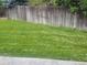 A grassy backyard with a wood fence creating a private outdoor space at 6123 S Quemoy Way, Aurora, CO 80015