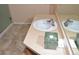 Bathroom sink with tan countertop, decorative tile floor, and large mirror at 6123 S Quemoy Way, Aurora, CO 80015