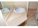 Bathroom sink with tan countertop, decorative tile floor, and large mirror at 6123 S Quemoy Way, Aurora, CO 80015