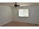 Neutral bedroom includes ceiling fan, window, and carpeted flooring at 6123 S Quemoy Way, Aurora, CO 80015