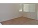 Neutral bedroom includes window and carpeted flooring at 6123 S Quemoy Way, Aurora, CO 80015