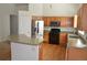 Bright kitchen with stainless steel appliances, wood cabinets, and ample counter space, creating a functional and stylish area at 6123 S Quemoy Way, Aurora, CO 80015