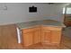 Kitchen island features wood cabinets, a gray countertop and laminate flooring at 6123 S Quemoy Way, Aurora, CO 80015