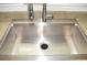 A stainless steel sink with a modern faucet, reflecting clean and functional design for easy food preparation and cleanup at 6123 S Quemoy Way, Aurora, CO 80015