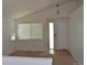 Open living room features vaulted ceilings and abundant natural light at 6123 S Quemoy Way, Aurora, CO 80015