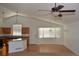 Open-concept living room with high ceilings, hardwood floors, and natural light, perfect for comfortable living and entertaining at 6123 S Quemoy Way, Aurora, CO 80015