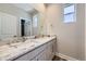 Modern bathroom boasts a double sink vanity with marble countertops and sleek fixtures at 858 Promenade Dr, Superior, CO 80027