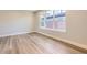 Well-lit bedroom featuring light wood floors and a large window at 858 Promenade Dr, Superior, CO 80027