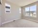 Bright bedroom featuring neutral walls, carpet, and natural light from three separate windows at 858 Promenade Dr, Superior, CO 80027