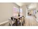Elegant dining room with hardwood floors, modern table, and plenty of natural light at 858 Promenade Dr, Superior, CO 80027