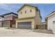 Two-story home with a dark gray garage door and a beige siding at 858 Promenade Dr, Superior, CO 80027