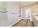 Hallway with hard surface floors leading to the main bathroom and closet space at 858 Promenade Dr, Superior, CO 80027