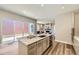 Open concept kitchen island with granite countertop, stainless sink, and stylish cabinets and hardware at 858 Promenade Dr, Superior, CO 80027