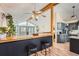 Living room wet bar with vaulted ceilings, wooden beams and a view of the kitchen at 2780 S Oakland W Cir, Aurora, CO 80014