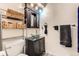 Modern bathroom with a glass vessel sink, dark cabinetry and stylish woven baskets for storage at 2780 S Oakland W Cir, Aurora, CO 80014