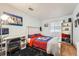 Sports-themed bedroom with bright bedding, work station, and natural light from the window at 2780 S Oakland W Cir, Aurora, CO 80014