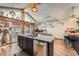 Kitchen island with countertop seating, stainless steel appliances, and expansive glass sliding doors at 2780 S Oakland W Cir, Aurora, CO 80014