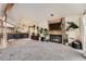 Bright living room with a brick fireplace, vaulted ceilings, and a breakfast bar with seating at 2780 S Oakland W Cir, Aurora, CO 80014