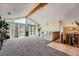 Open living room featuring vaulted ceilings, large windows, and a staircase with wood railing at 2780 S Oakland W Cir, Aurora, CO 80014