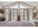 Bright living room featuring vaulted ceilings, large windows, neutral tones, and access to the balcony at 2780 S Oakland W Cir, Aurora, CO 80014