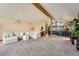 Spacious open-concept living area with vaulted ceilings, a bar, and a comfortable sectional sofa at 2780 S Oakland W Cir, Aurora, CO 80014