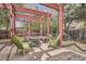 Cozy backyard patio with a fire pit and red wood pergola, perfect for outdoor entertaining at 2780 S Oakland W Cir, Aurora, CO 80014