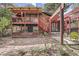 Exterior view of a multi-level deck, brick accents, and a spacious backyard with patio area at 2780 S Oakland W Cir, Aurora, CO 80014