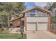 Inviting two-story home features a brick facade, two-car garage, and well-manicured front yard at 2780 S Oakland W Cir, Aurora, CO 80014