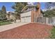 A cozy home with a brick chimney, two car garage, and well manicured flower bed at 2780 S Oakland W Cir, Aurora, CO 80014